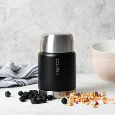 Ever eco onyx insulated food jar thermos with silver lid on a white surface with berries and granola.