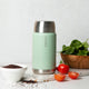 Ever Eco Sage thermos with silver lid on a white surface with ingredients