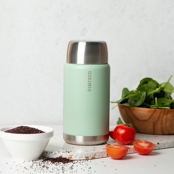 Ever Eco Sage thermos with silver lid on a white surface with ingredients