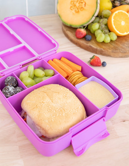 MontiiCo Feast Lunch Box - Fuchsia open with compartments and snacks