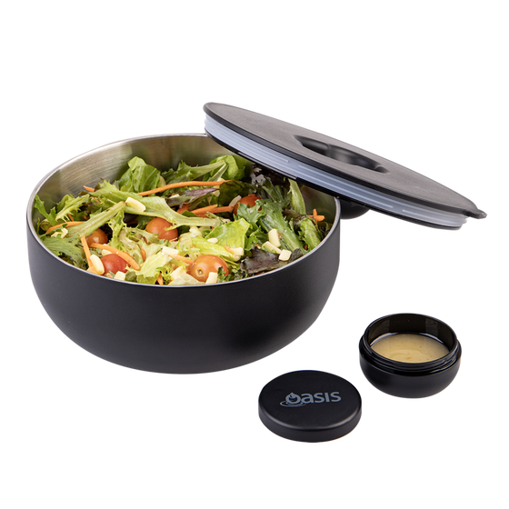 Oasis Black lunch bowl with a lid, salad, and dressing container on a white background